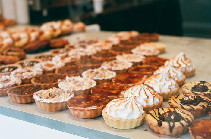 A selection of tarts in a bakery window