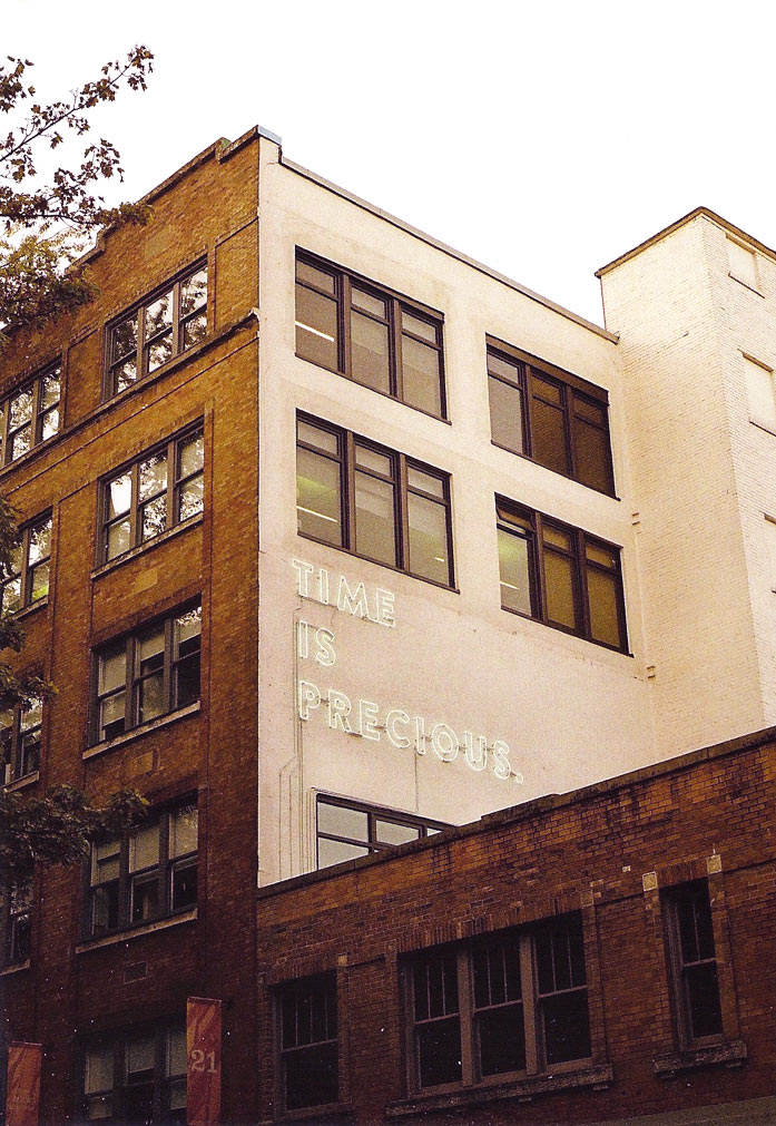 Neon sign reading "Time is Precious"