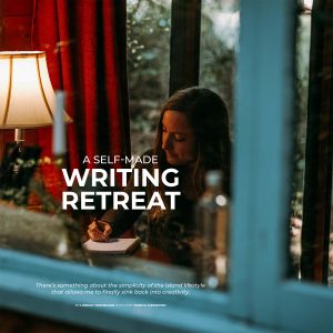 A woman writing in a notebook, as seen from outside a rustic cabin looking through the window. Text overlay: A Self-Made Writing Retreat.